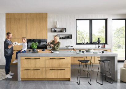 Familienfreundliche Küche in heller Holzoptik mit Kochinsel und klaren Linien, viel Stauraum und funktionale Gestaltung für gemeinsames Kochen und Alltag